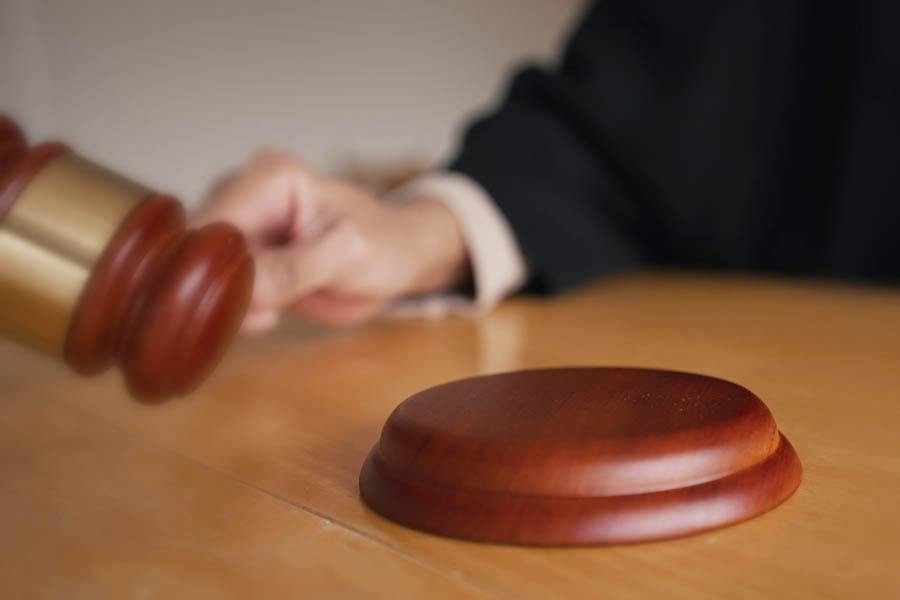 A stressed homeowner checking an online credit report detailing a county court judgment